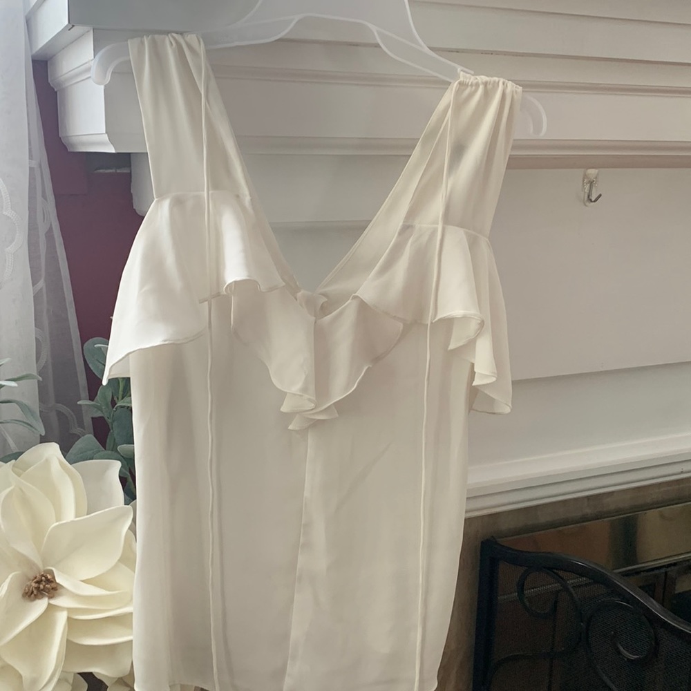 XS white ruffle detail blouse from Express in excellent used condition.